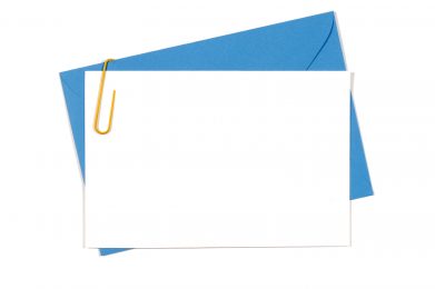 Blank invitation or message card with blue envelope and yellow paperclip